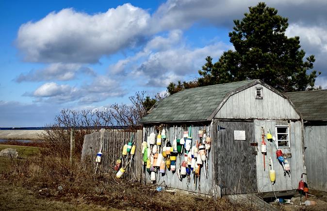 Image of an outbuilding covered in colorful buoys in Scituate, Massachusetts